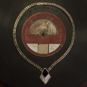Vintage record with decorative gold necklace.