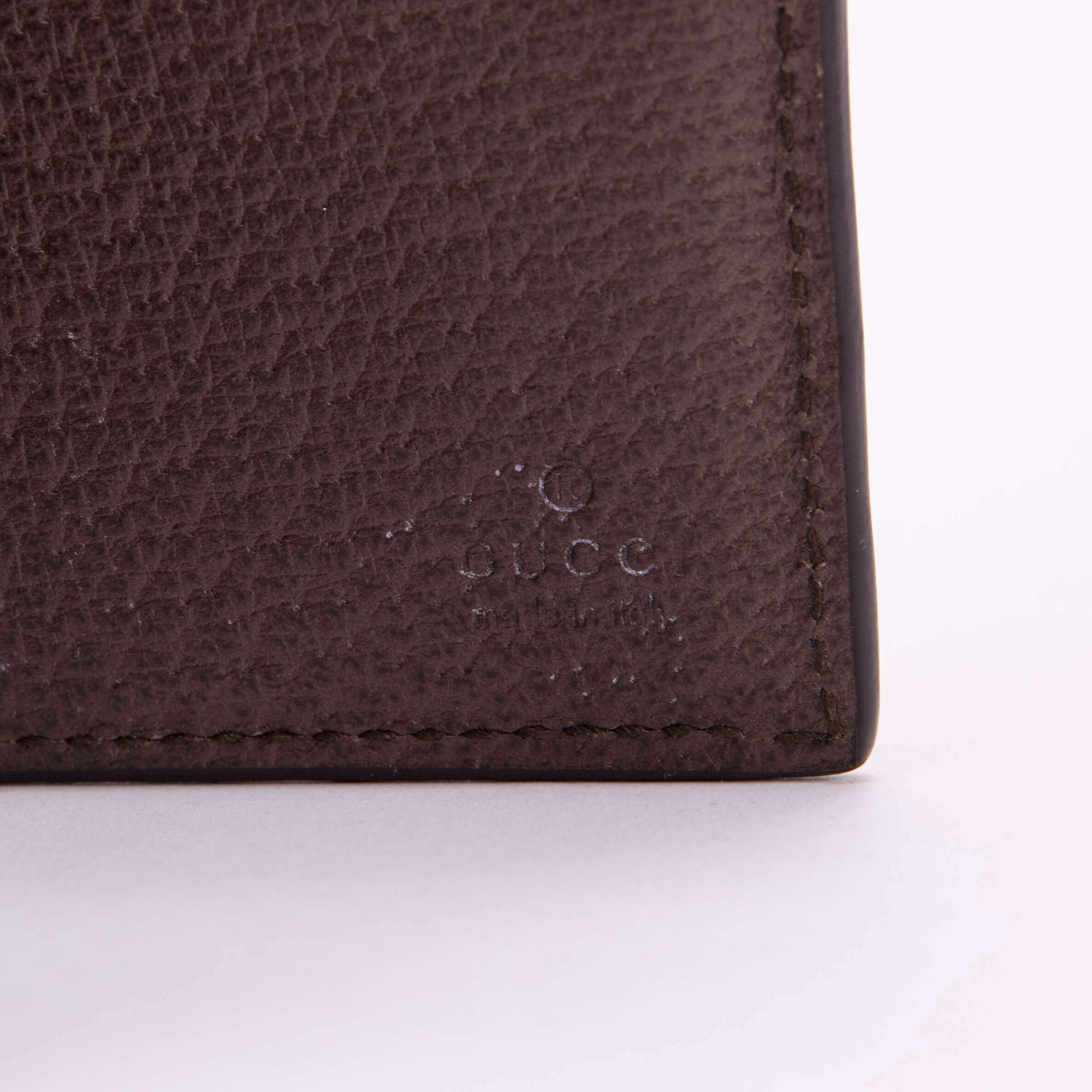 Close-up of a brown leather wallet corner.