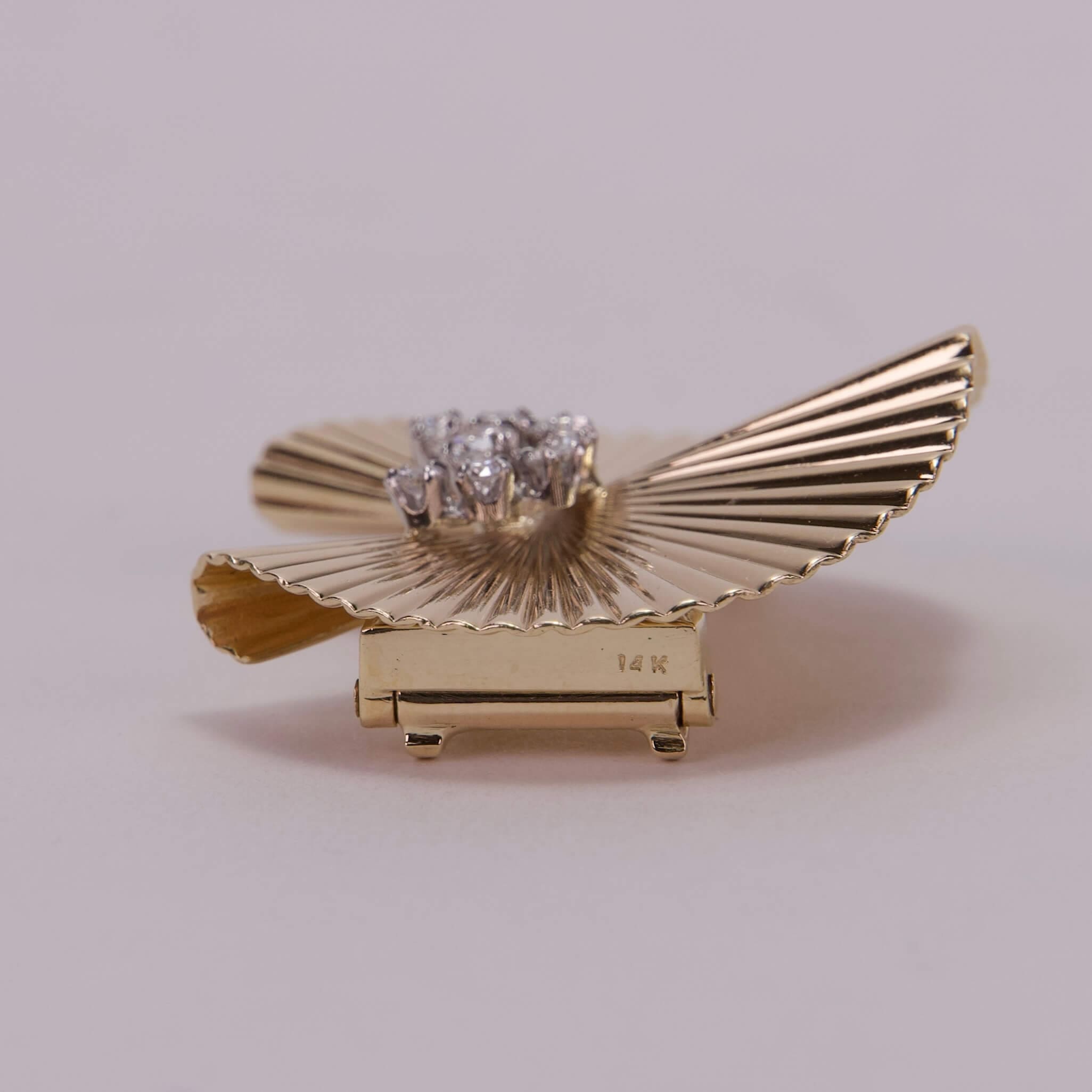 Gold ring with fan design and diamonds.