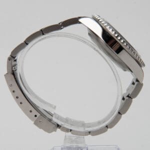 Luxury watch with metal bracelet, side view.