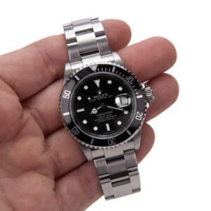 Hand holding a luxury wristwatch.