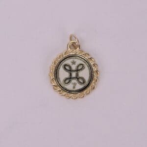 Gold pendant with intricate circular design.