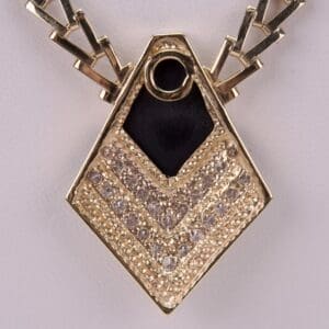 Gold pendant with geometric design and gemstones.
