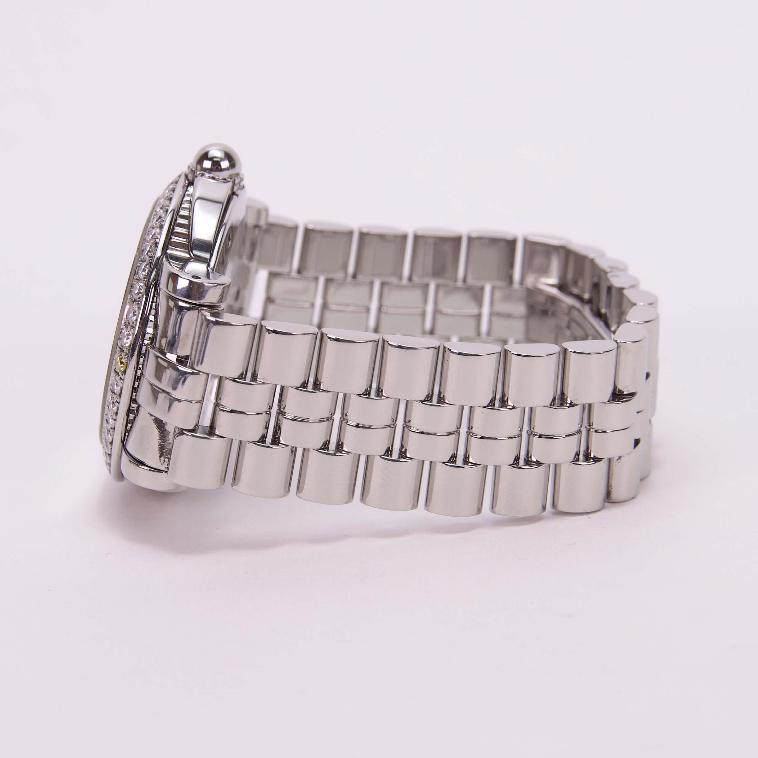 Silver watch with metal bracelet strap.