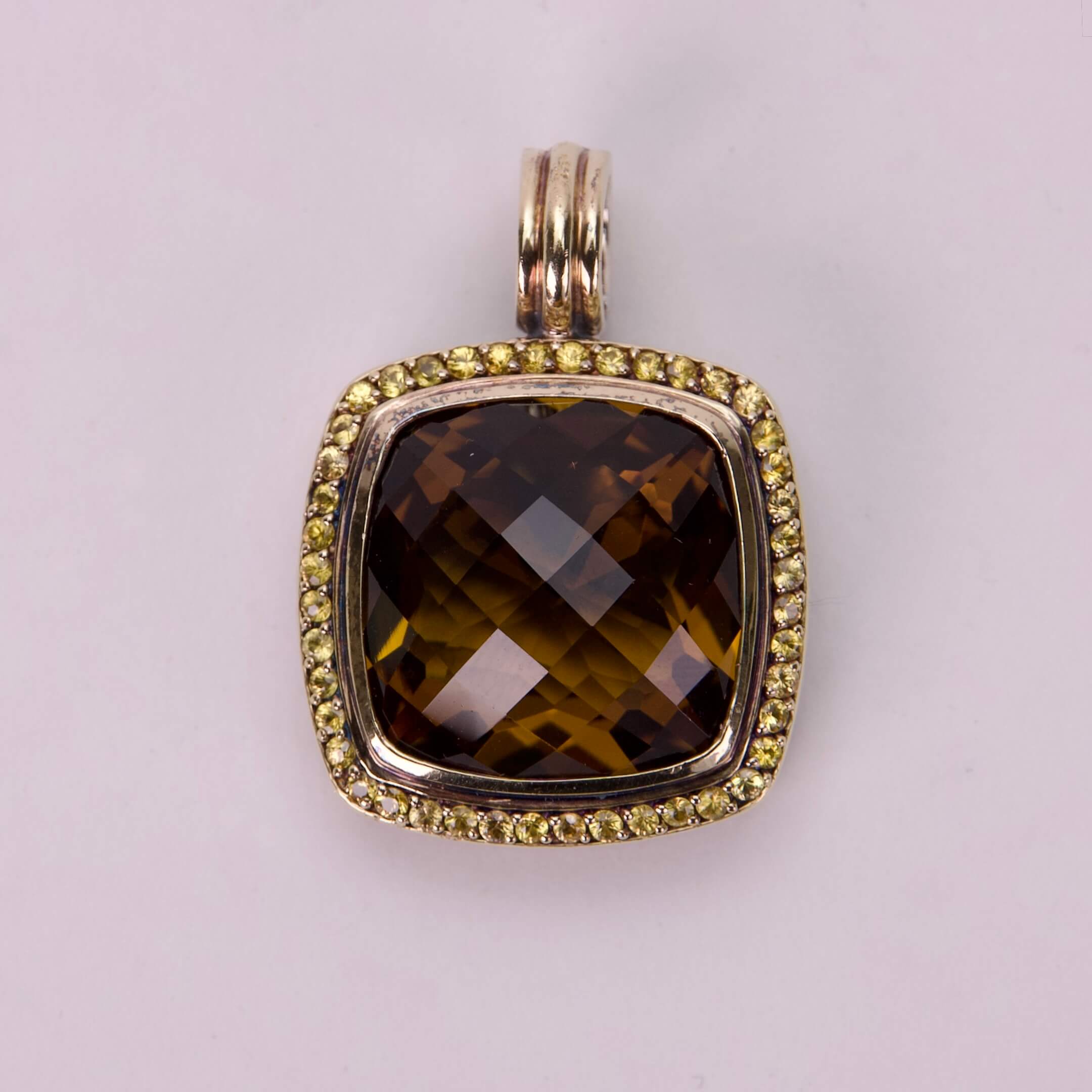 Brown gemstone pendant with yellow gemstone border.