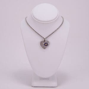 Heart-shaped necklace with evil eye pendant.