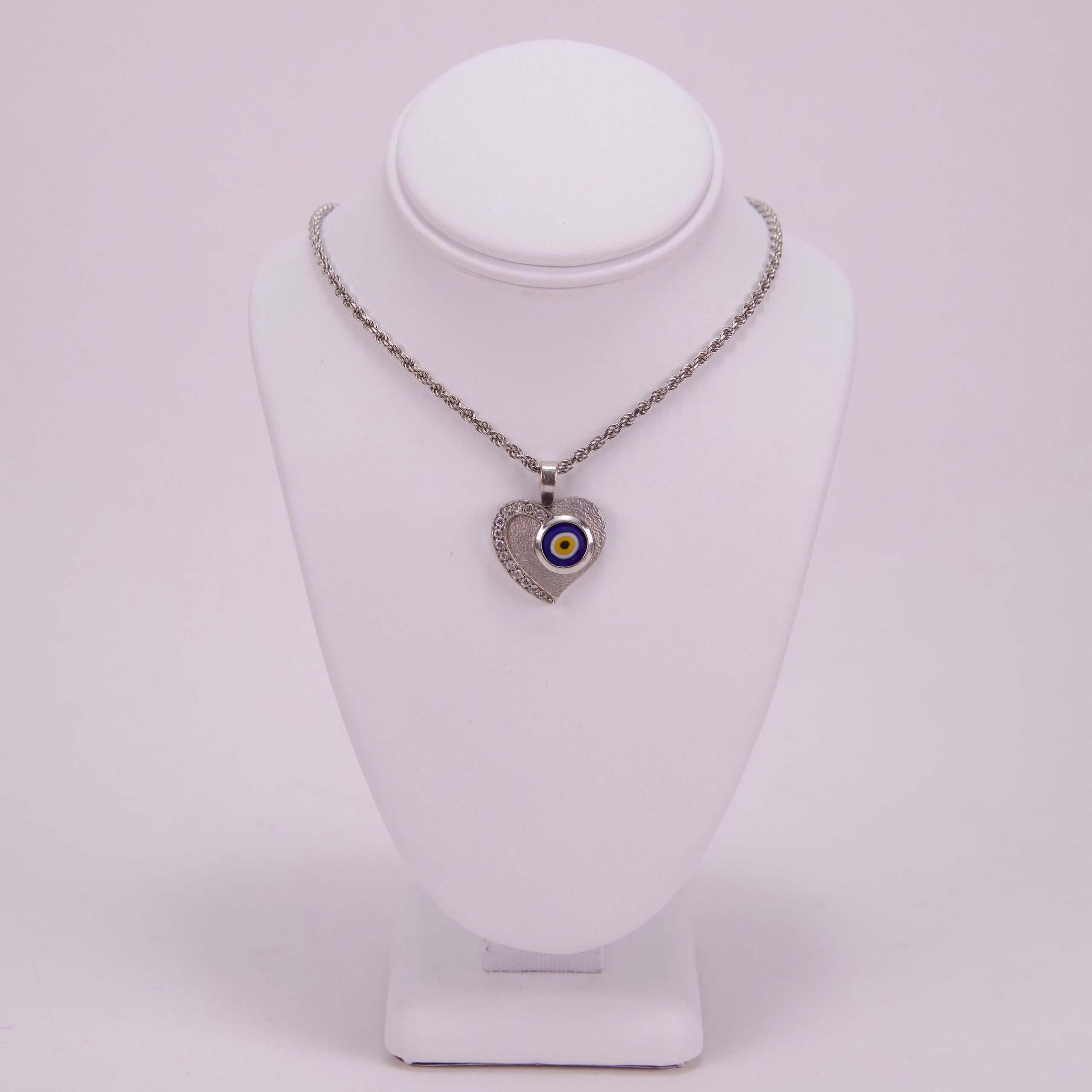 Heart-shaped necklace with evil eye pendant.