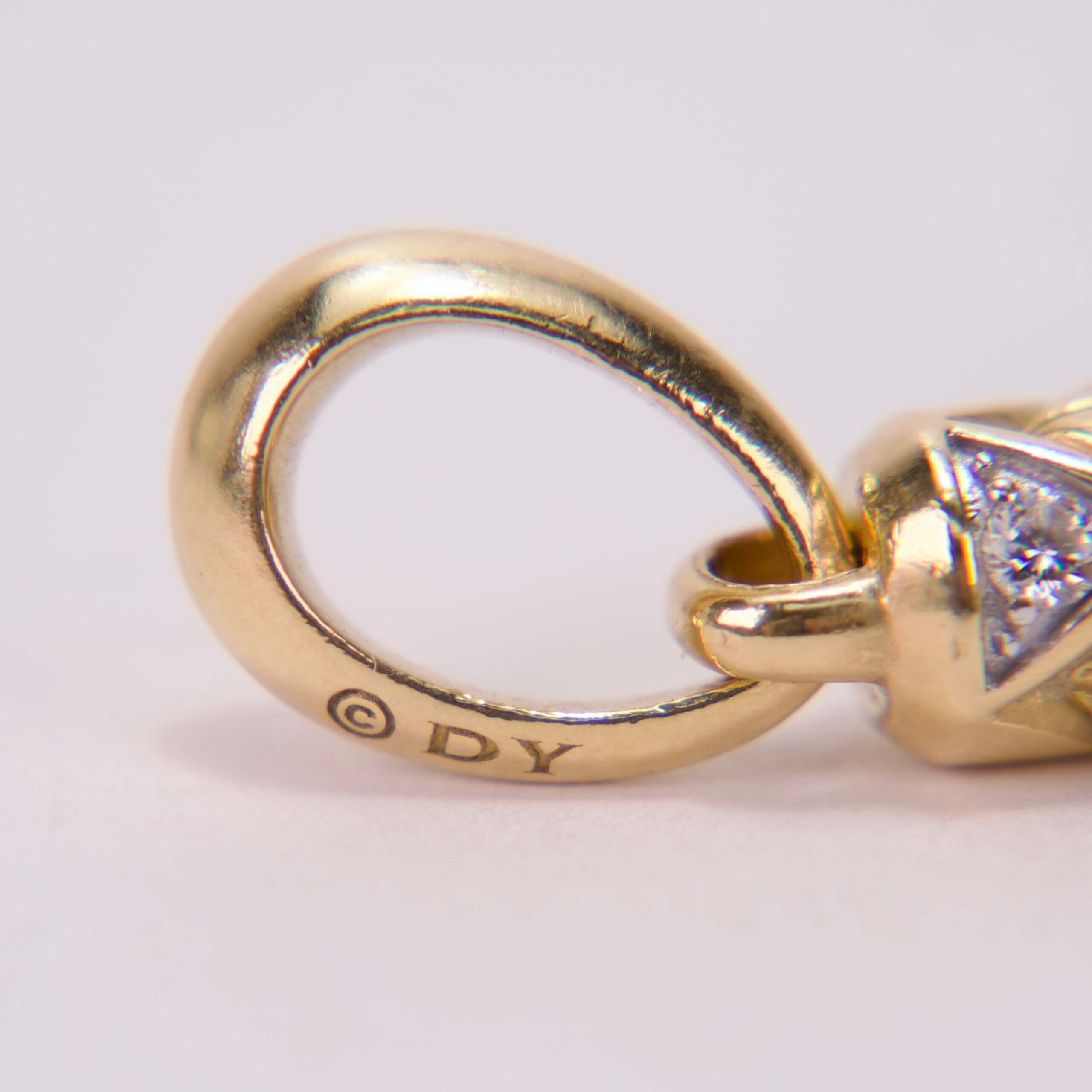 Gold jewelry loop with diamond detail.
