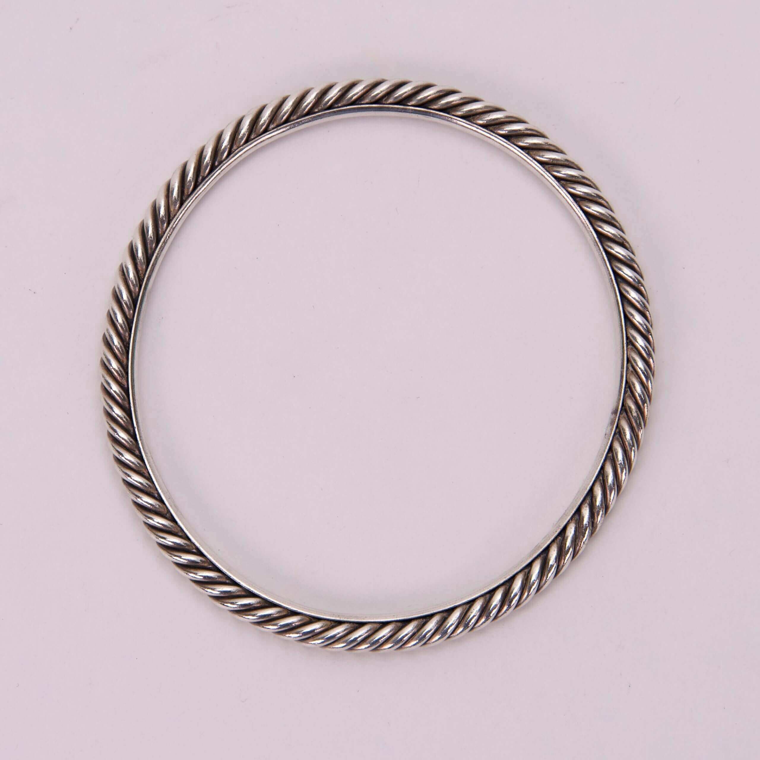 Silver twisted rope design bangle bracelet.