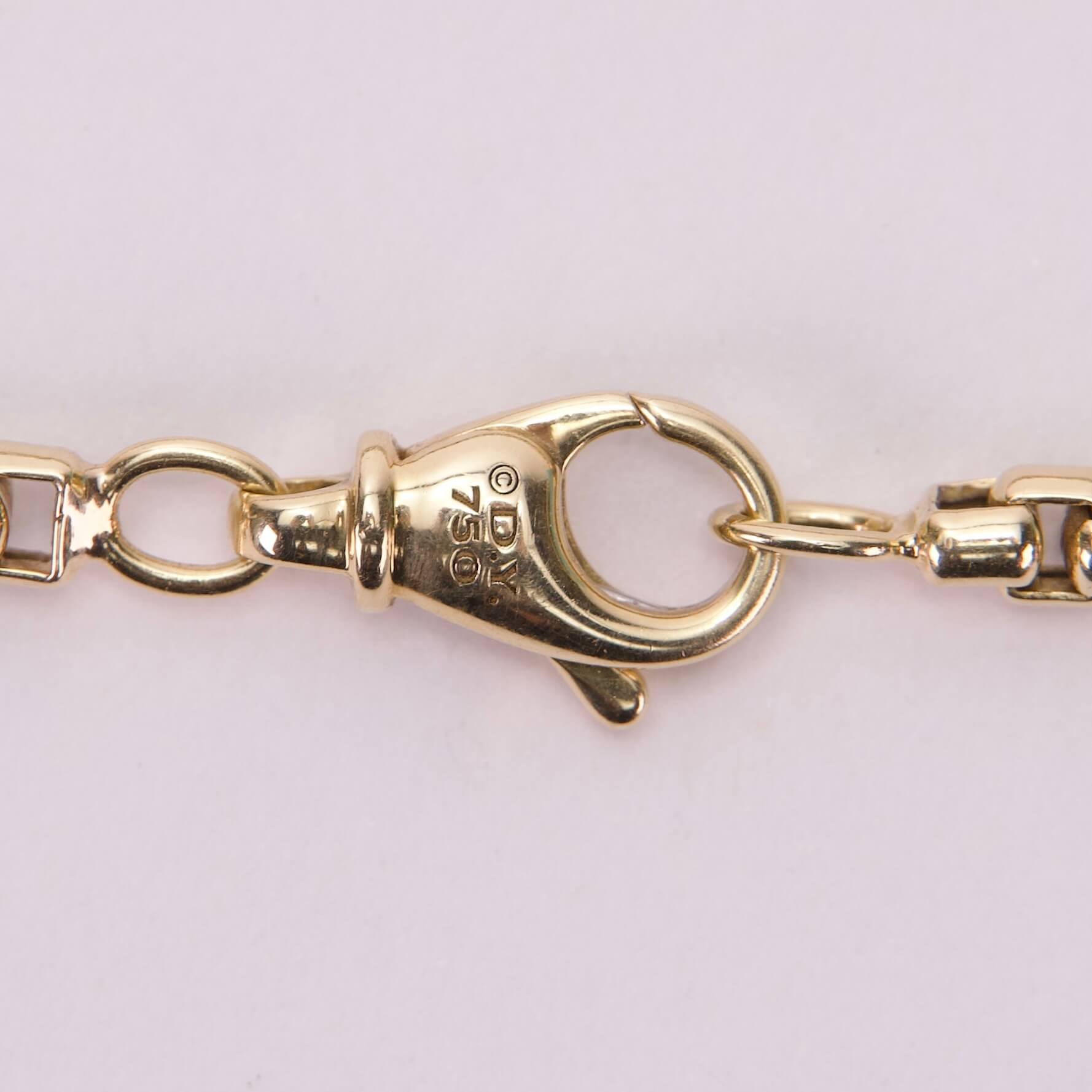Gold chain lobster clasp close-up.