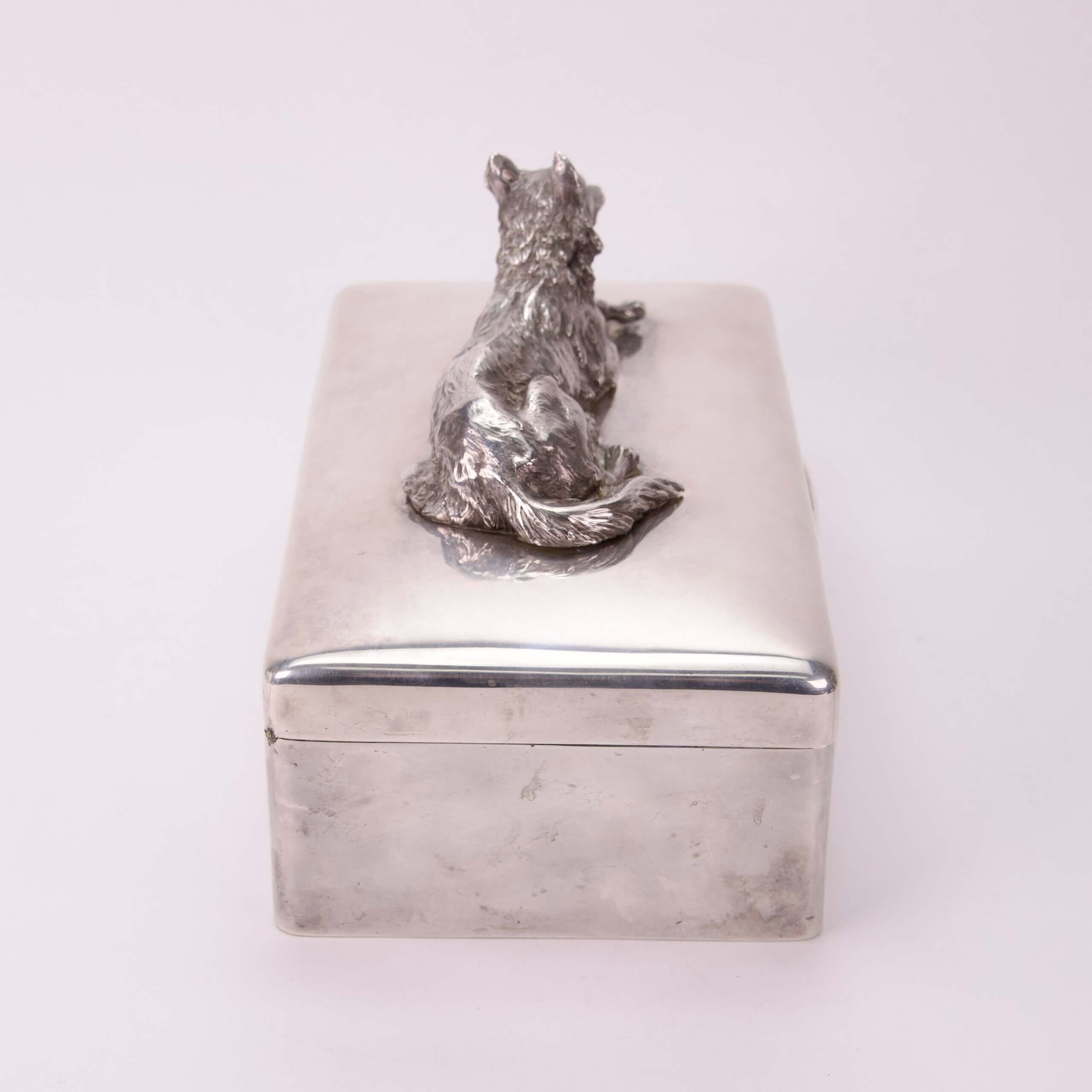 Silver box with dog figure on lid.