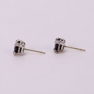 Silver earrings with black gemstone accents.