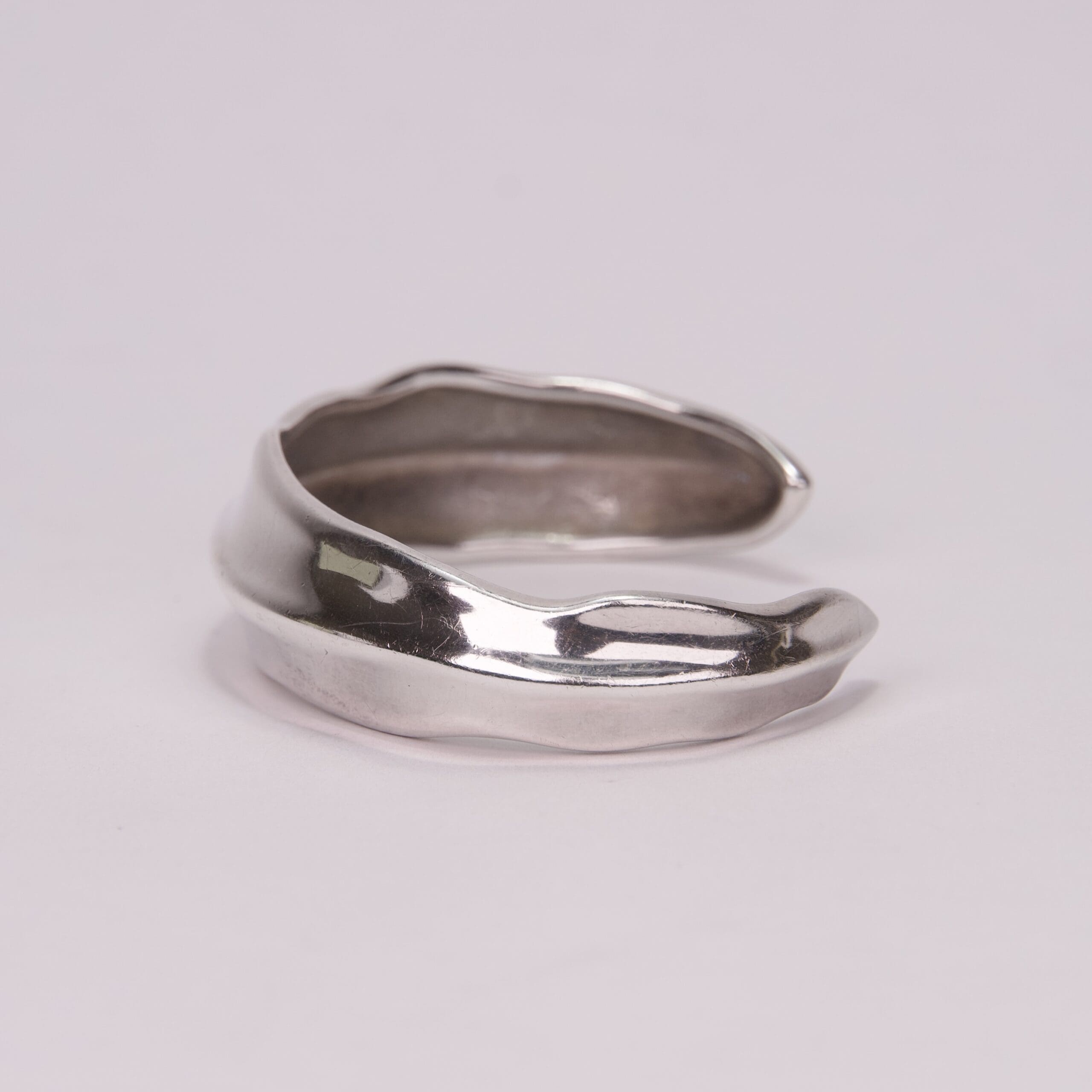 Silver open cuff ring on display.