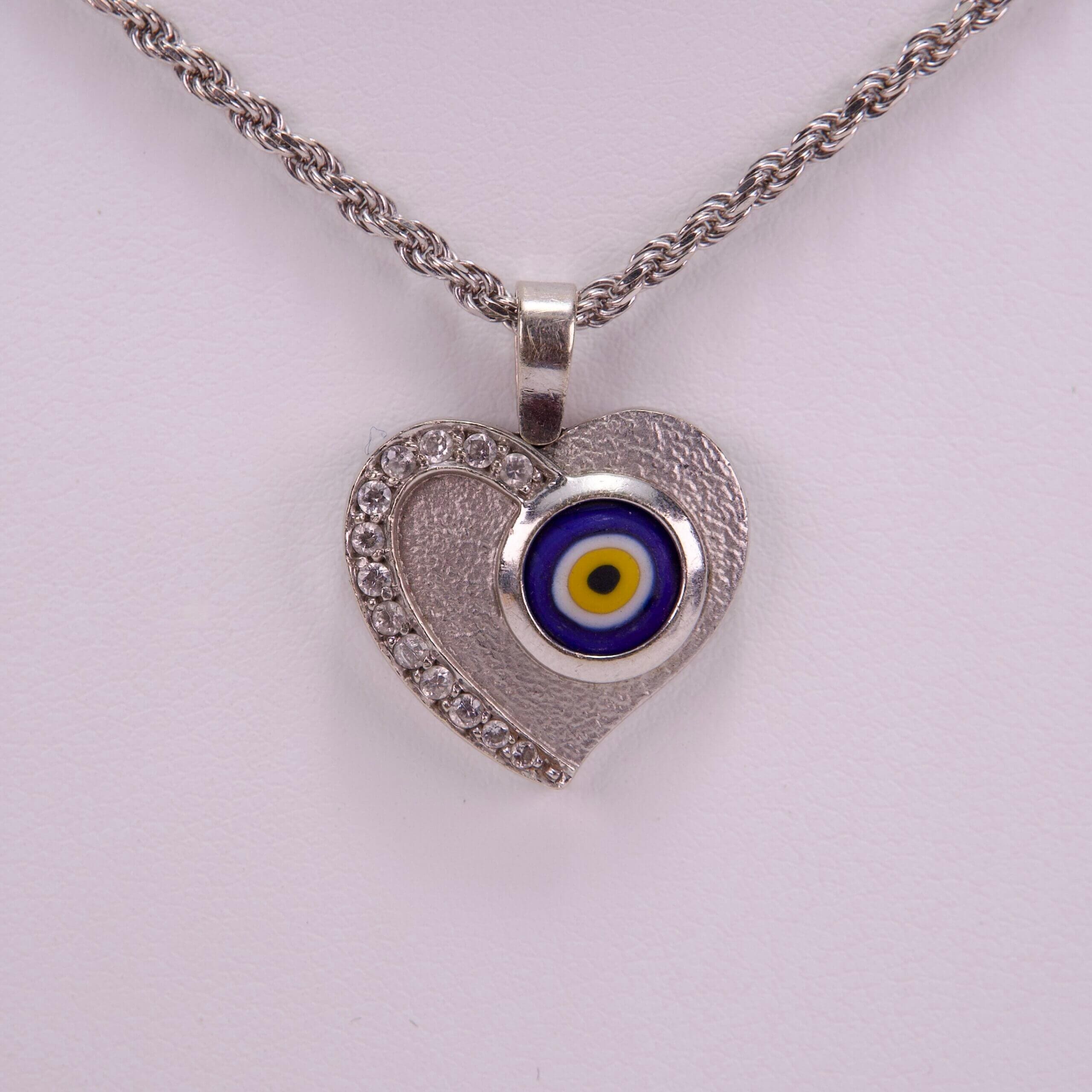 Heart necklace with evil eye pendant.