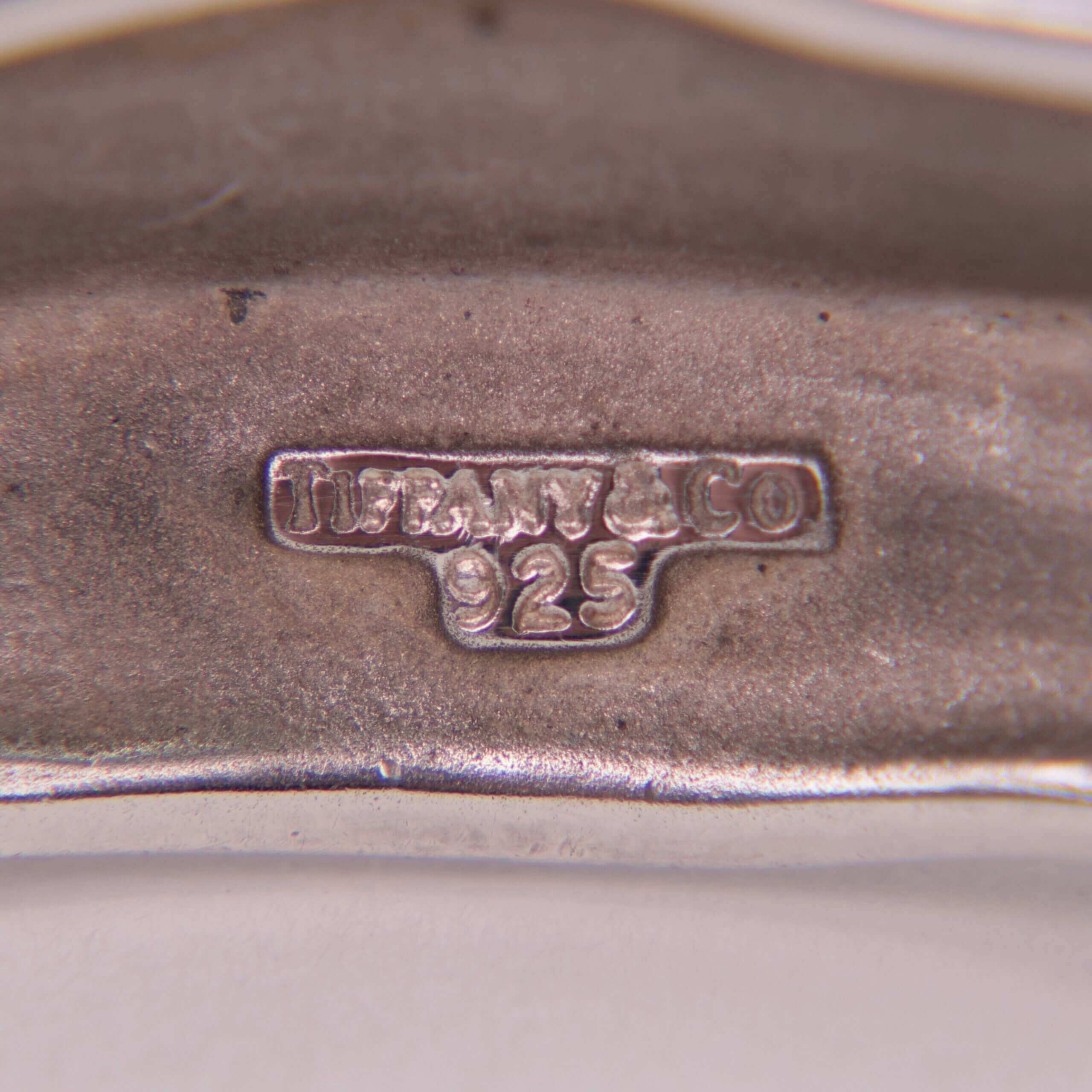 Close-up of a silver hallmark stamp.