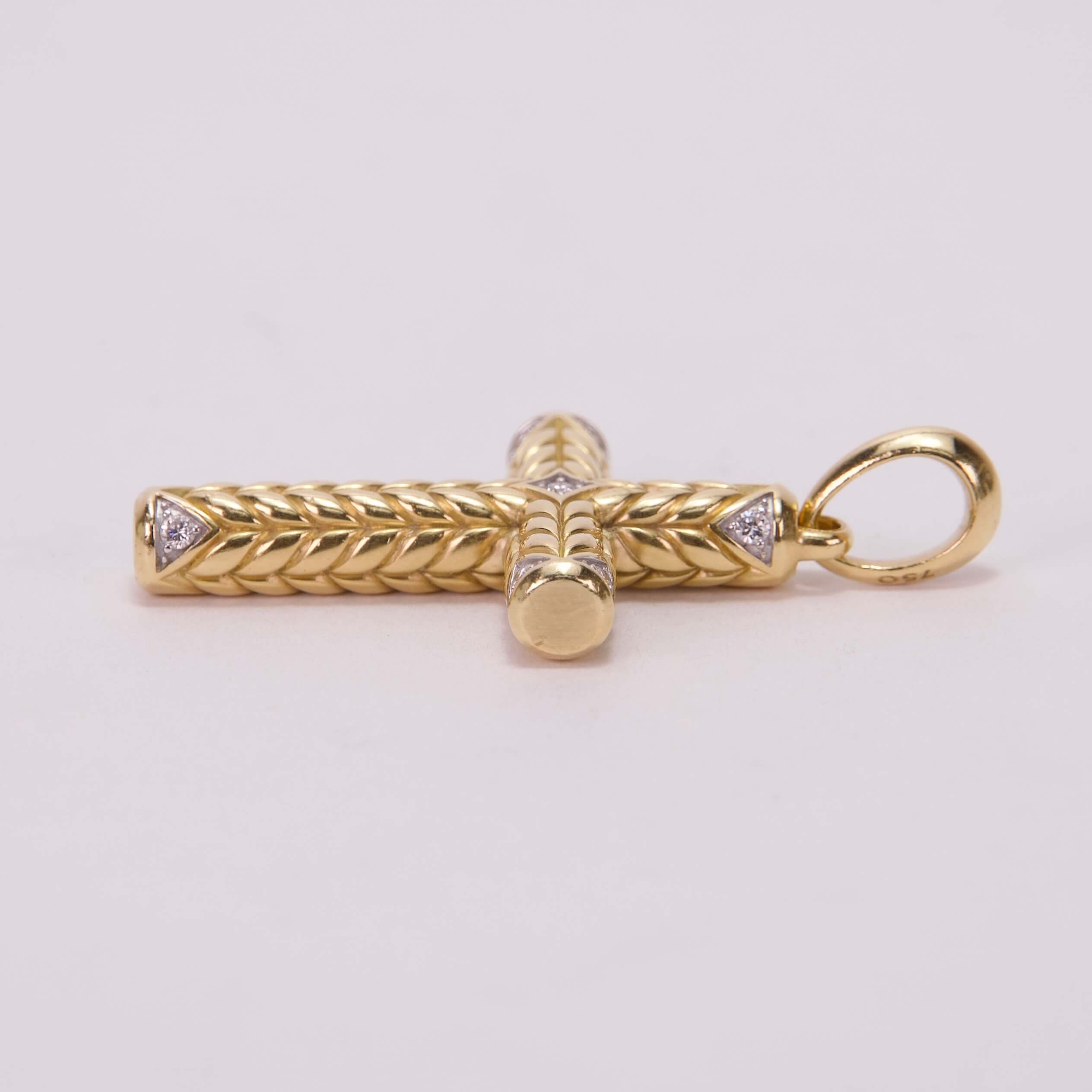 Gold cross pendant with intricate braid design.