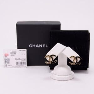 Chanel gold stud earrings with packaging.