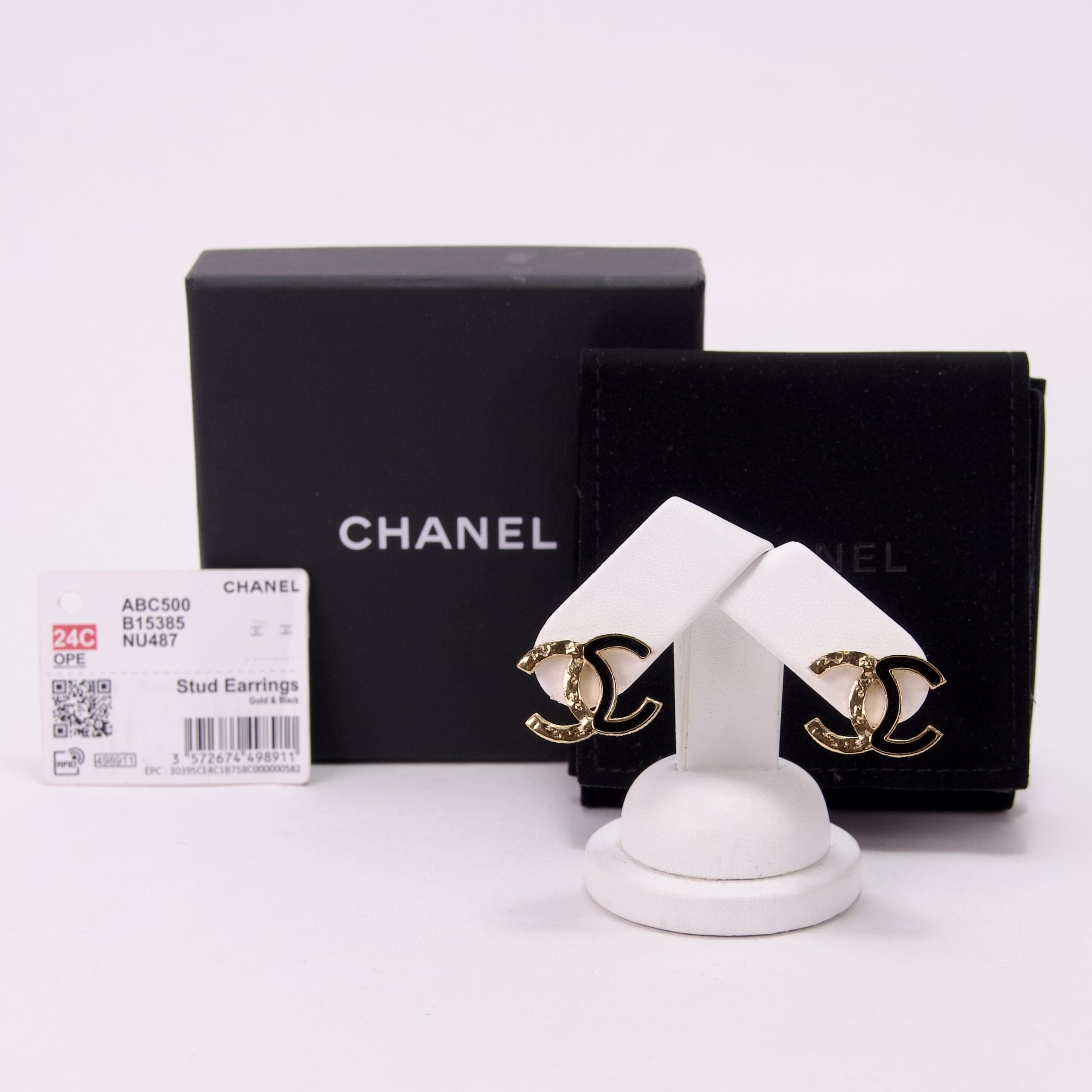Chanel gold stud earrings with packaging.