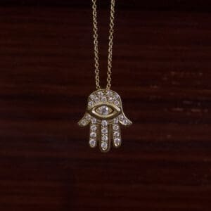 Hamsa hand necklace with eye design.