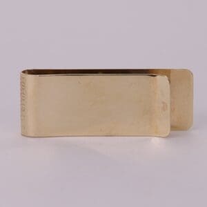 Gold metal money clip, plain design.