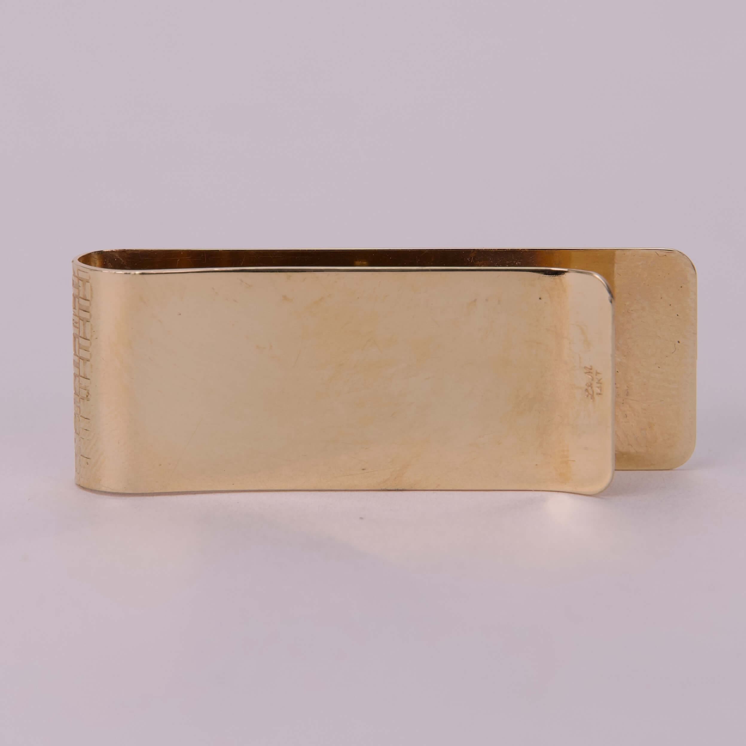 Gold metal money clip, plain design.