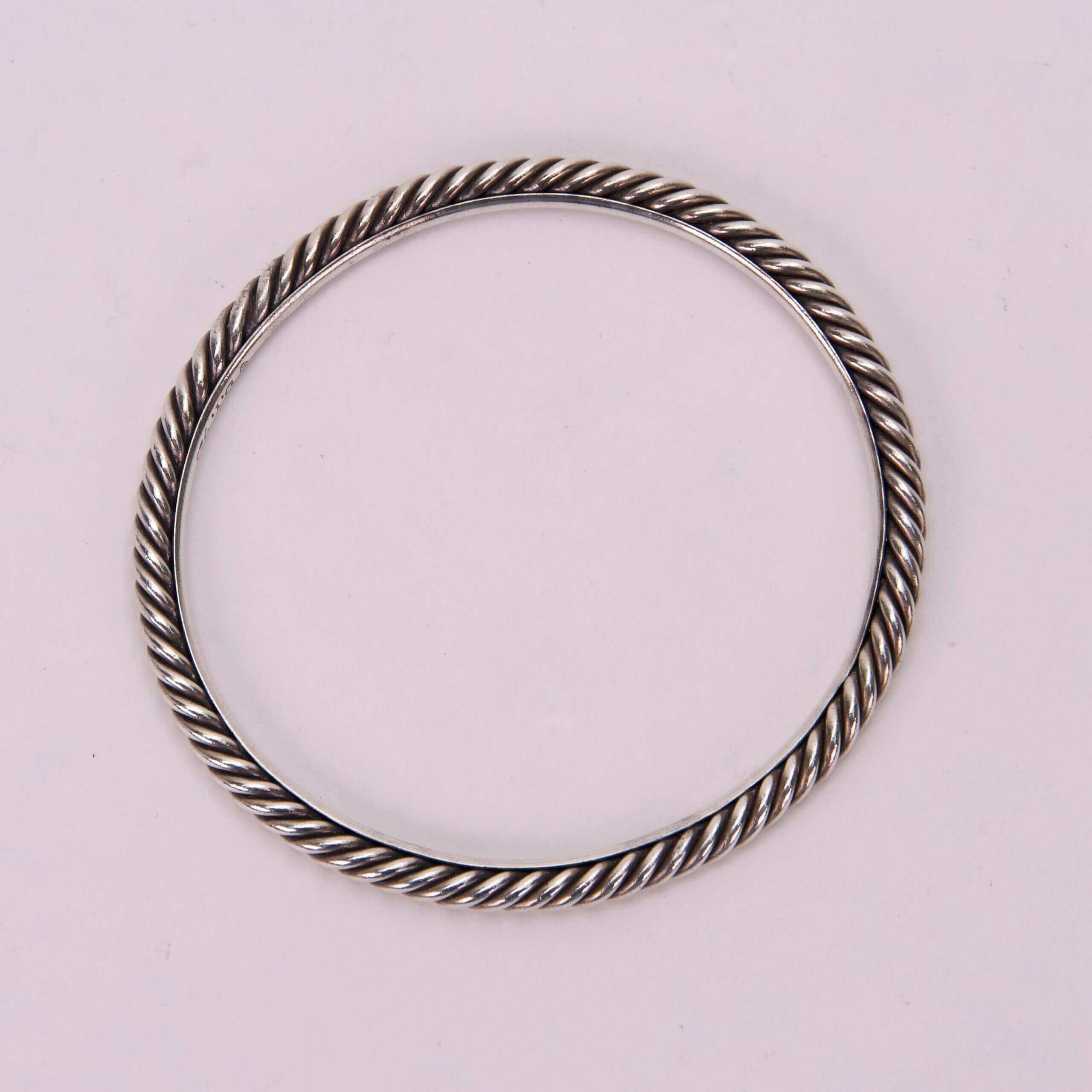 Silver twisted rope-style bracelet on display.