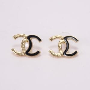 Gold and black logo earrings on display.