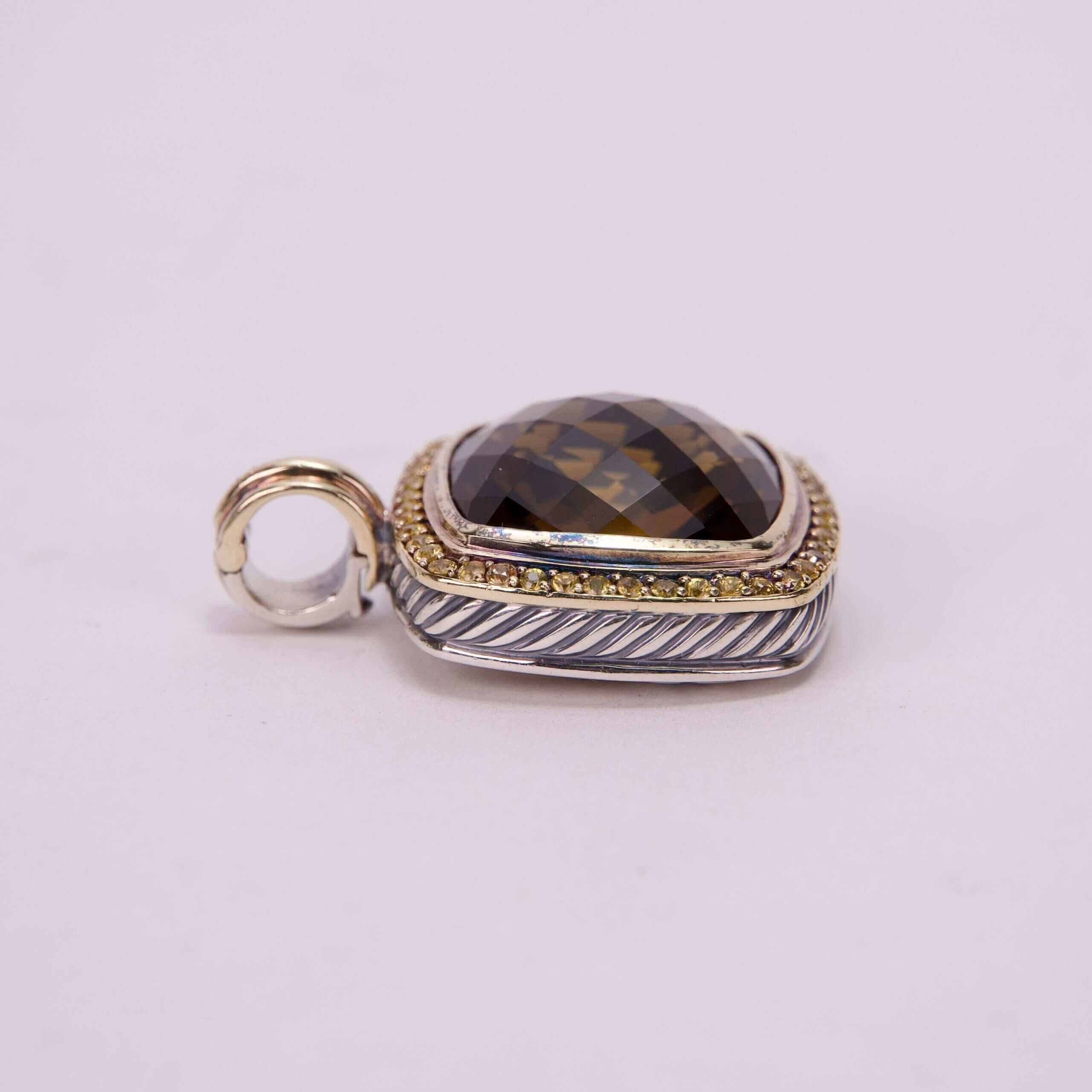 Gemstone pendant with gold and silver accents.