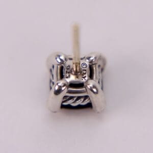 Close-up of a silver earring stud.
