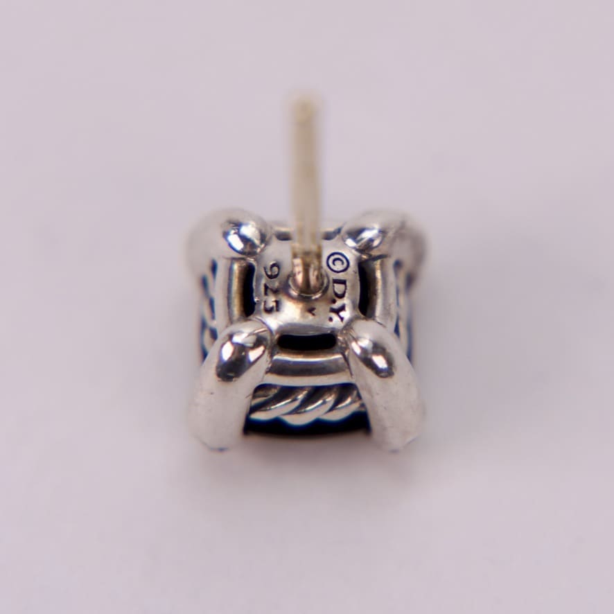 Close-up of a silver earring stud.