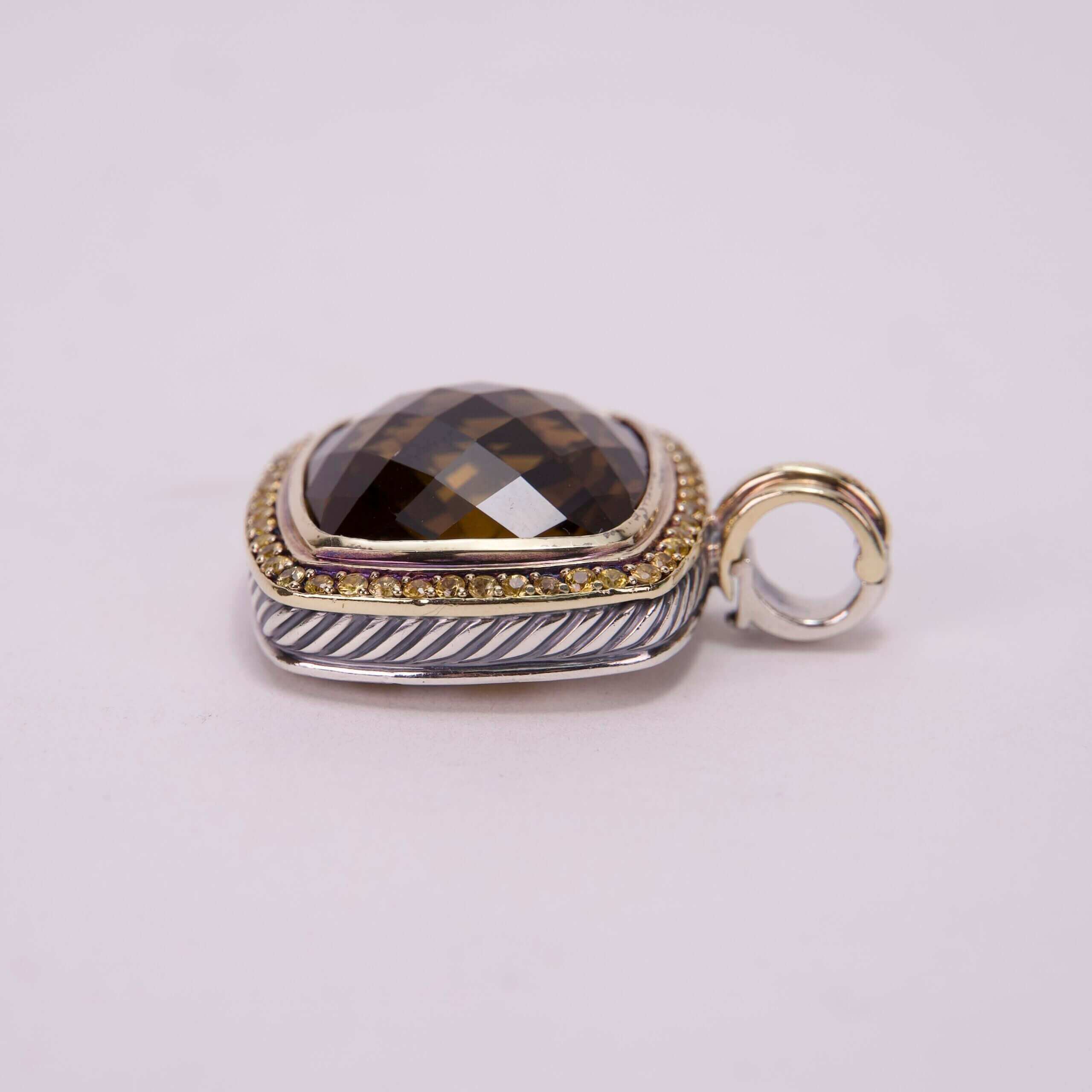 Faceted gemstone pendant with gold accents.