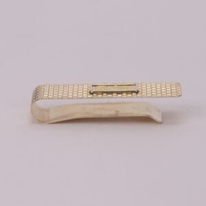 Gold textured money clip on white background.