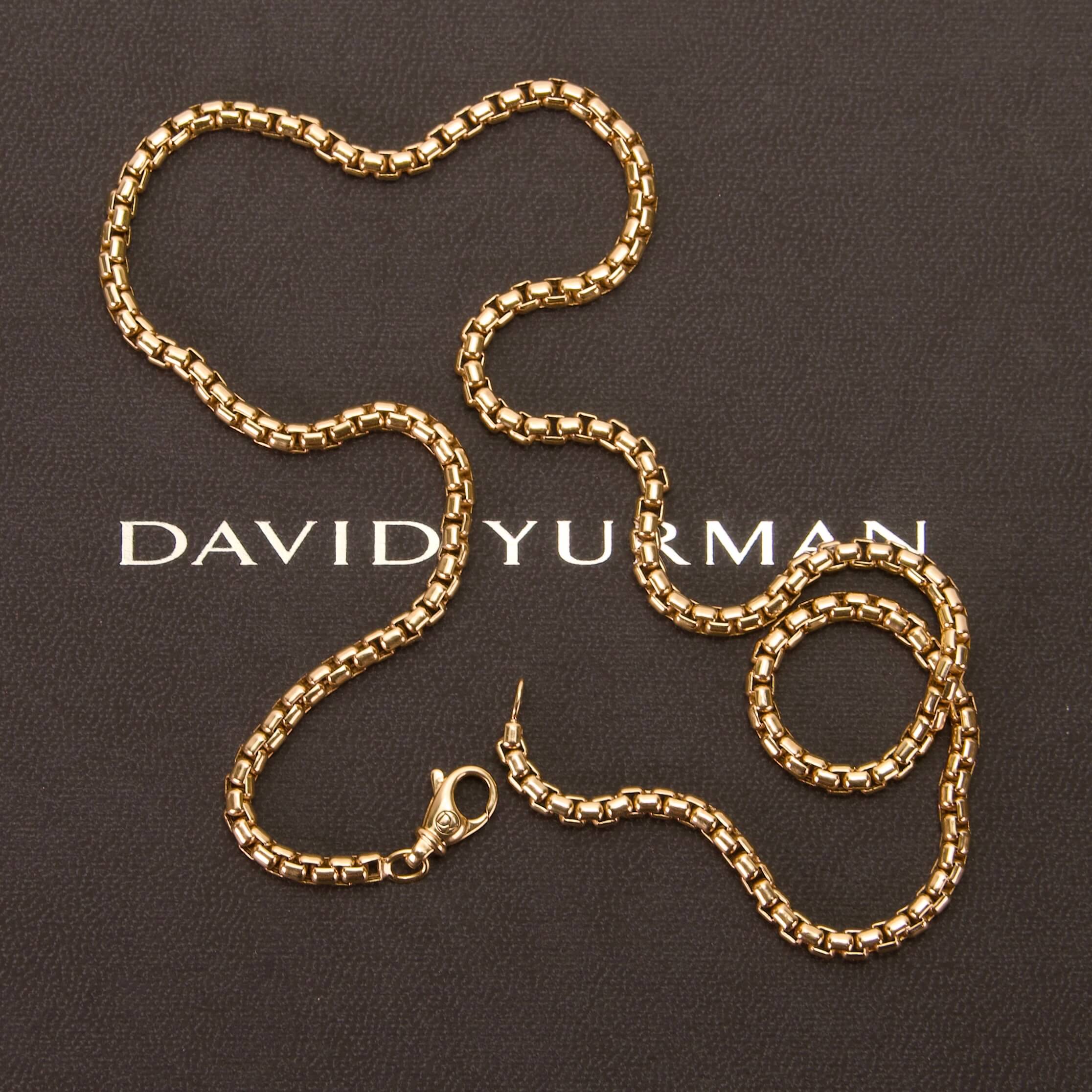 Gold chain on David Yurman branded surface.