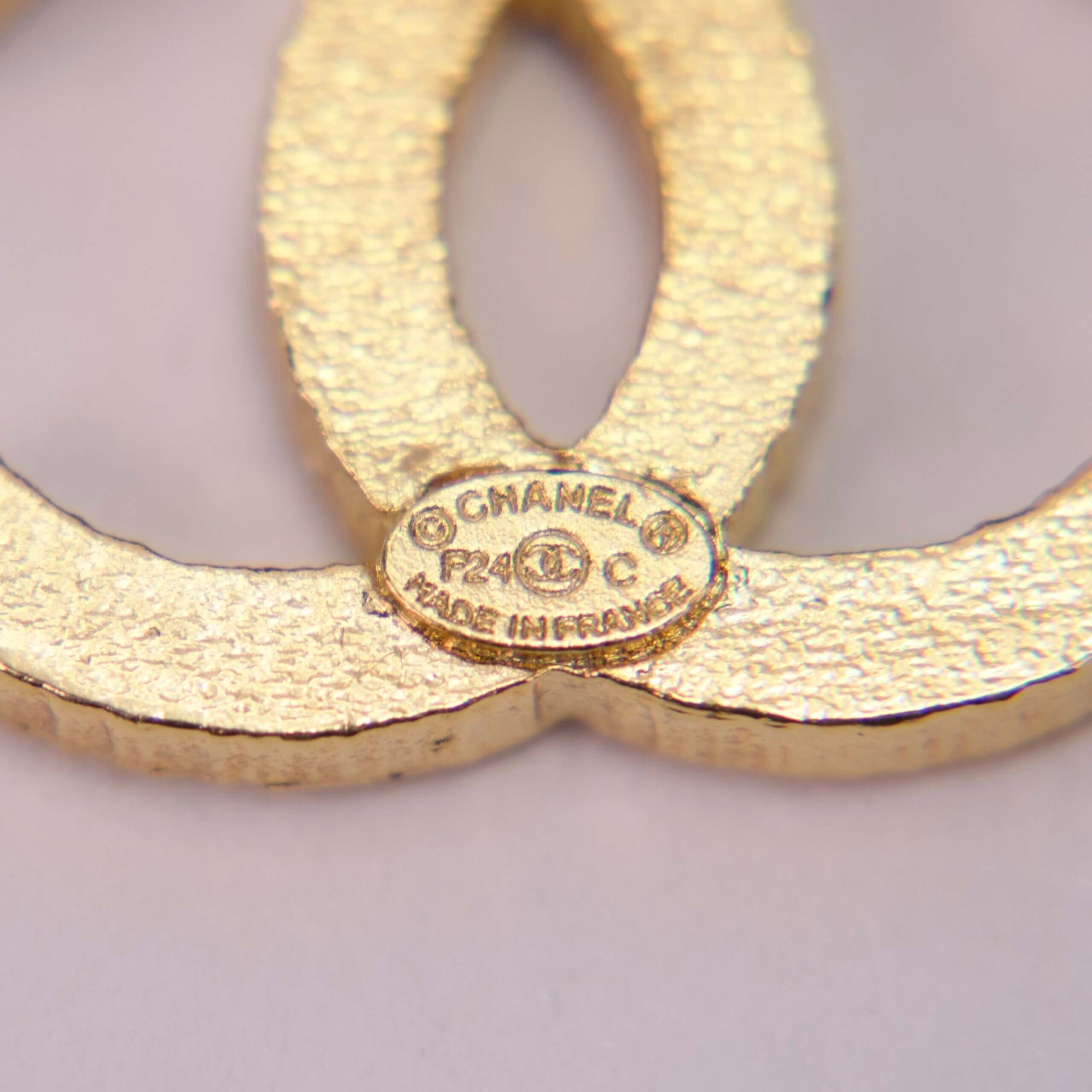 Gold Chanel logo close-up with label.