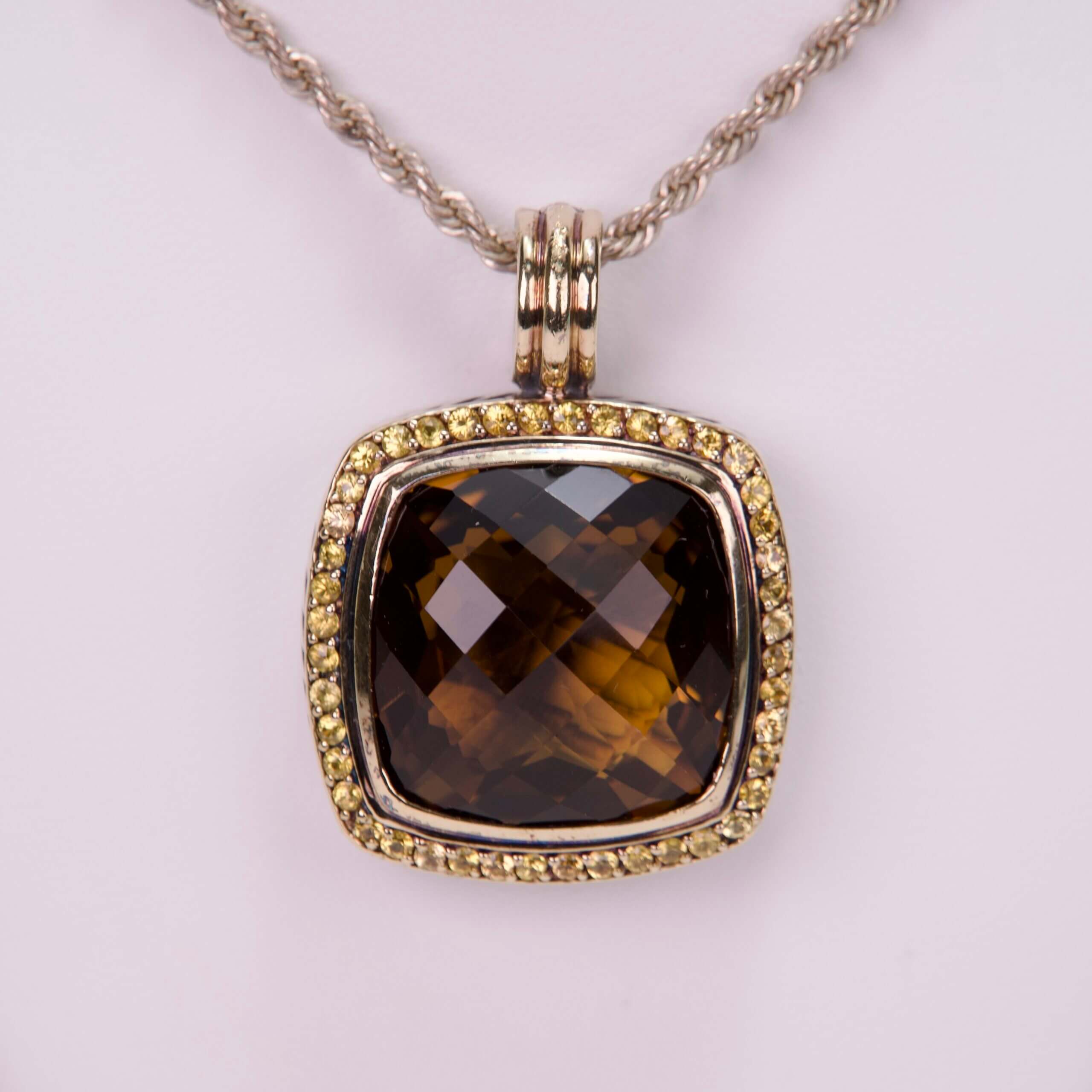Square gemstone pendant with yellow accents.