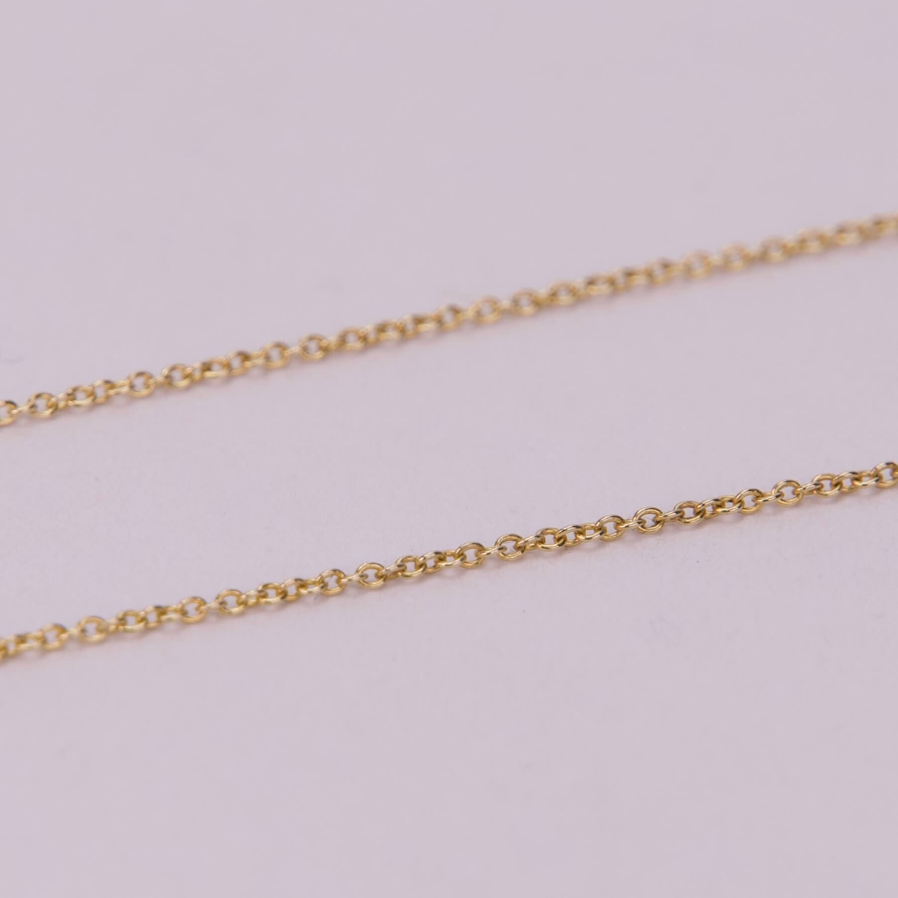 Gold chain on a light background.