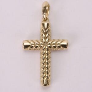 Gold cross pendant with engraved details.