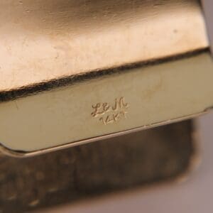 Gold jewelry with "L&M 14KT" engraving.