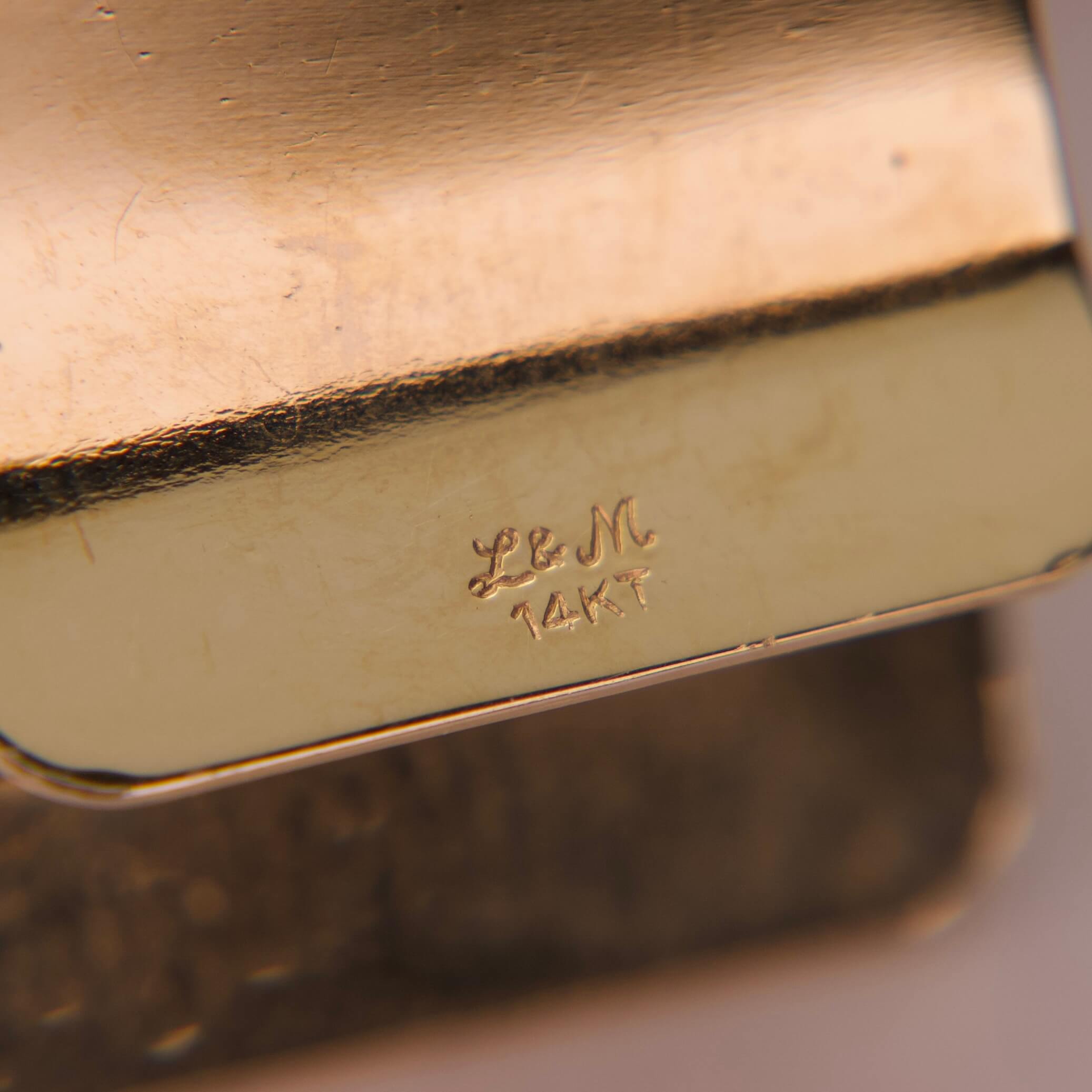 Gold jewelry with "L&M 14KT" engraving.