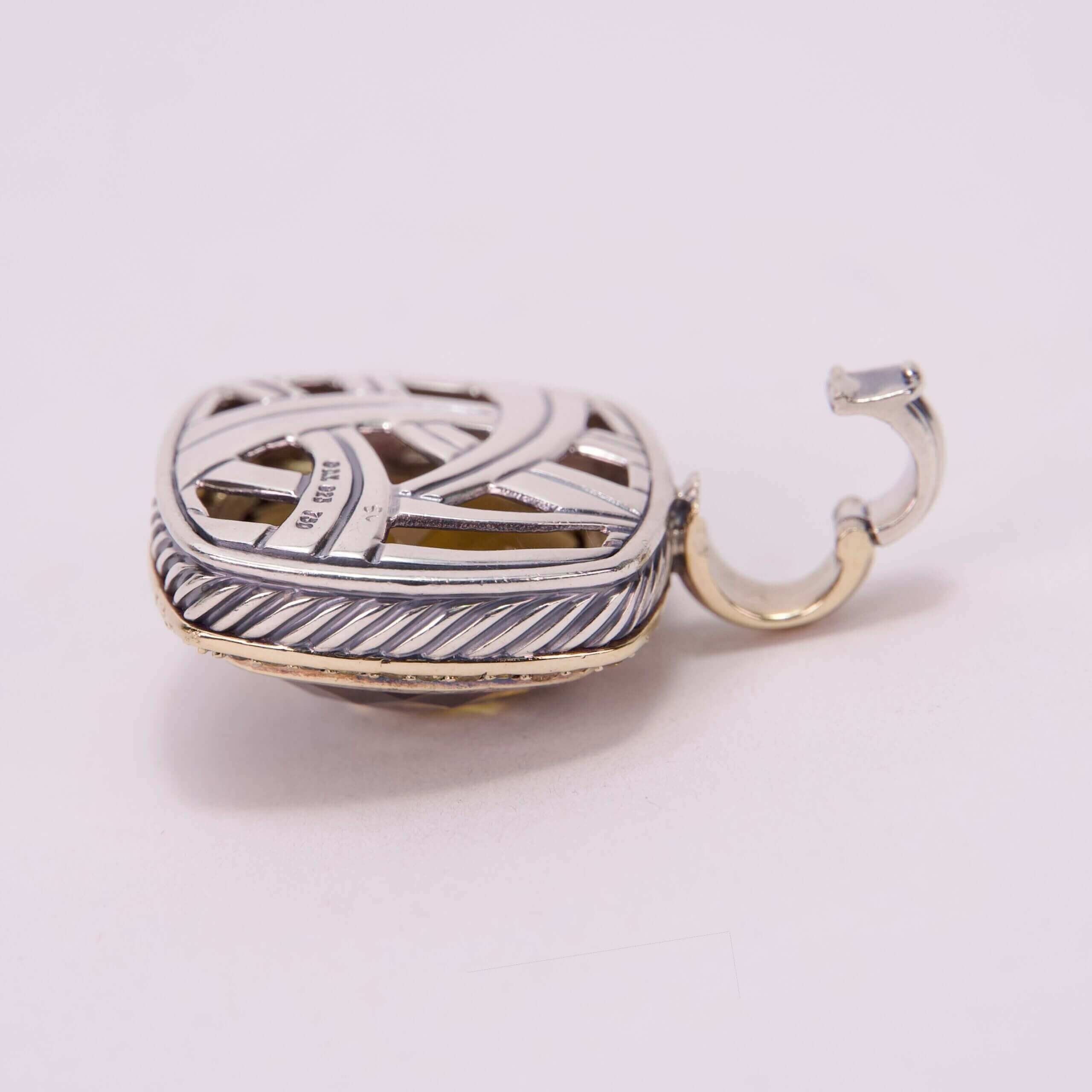 Silver and gold decorative hook on display.