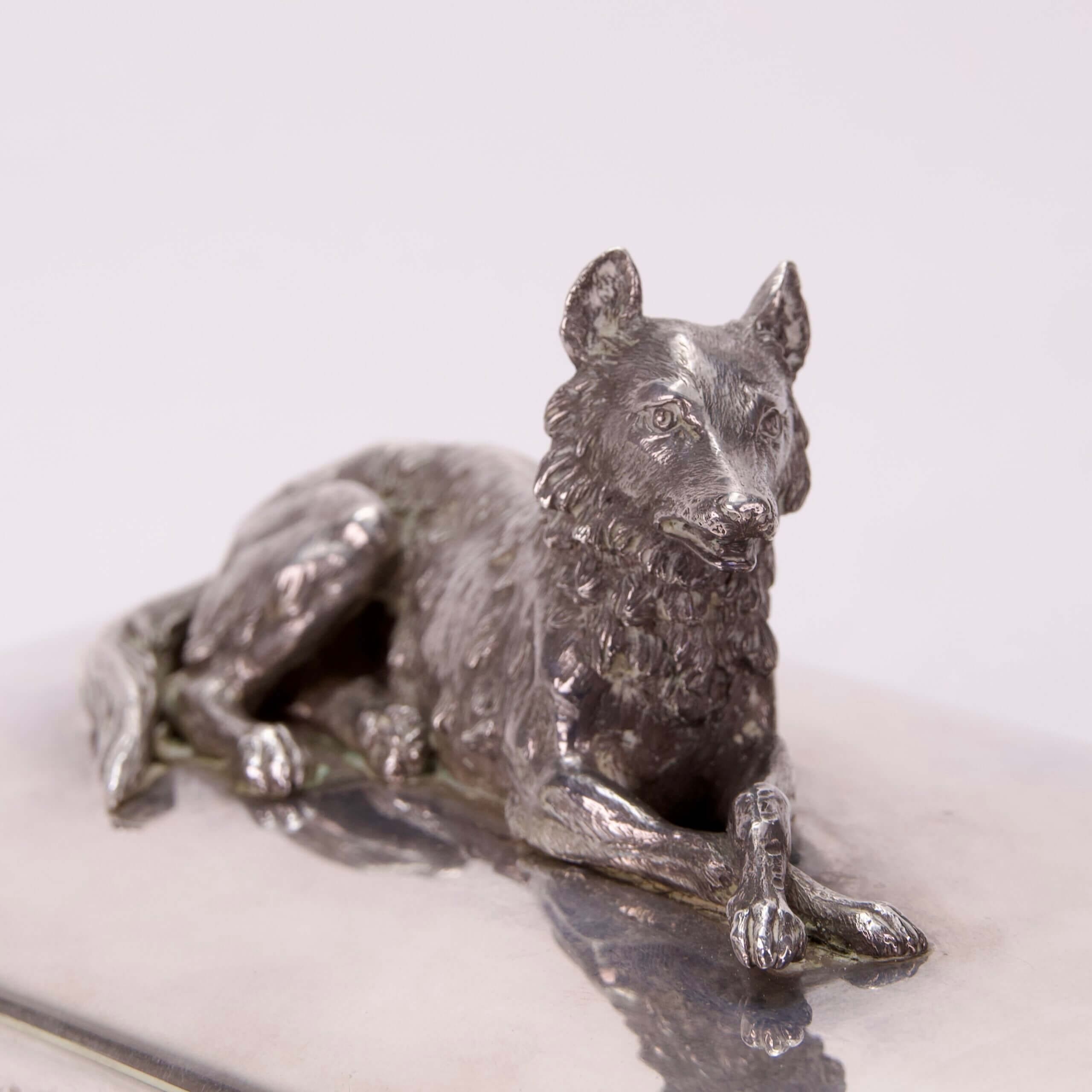 Silver wolf figurine lying down gracefully.