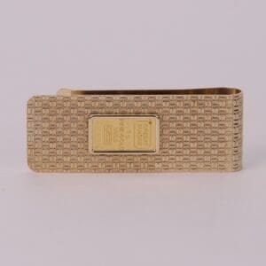 Gold money clip with textured design.