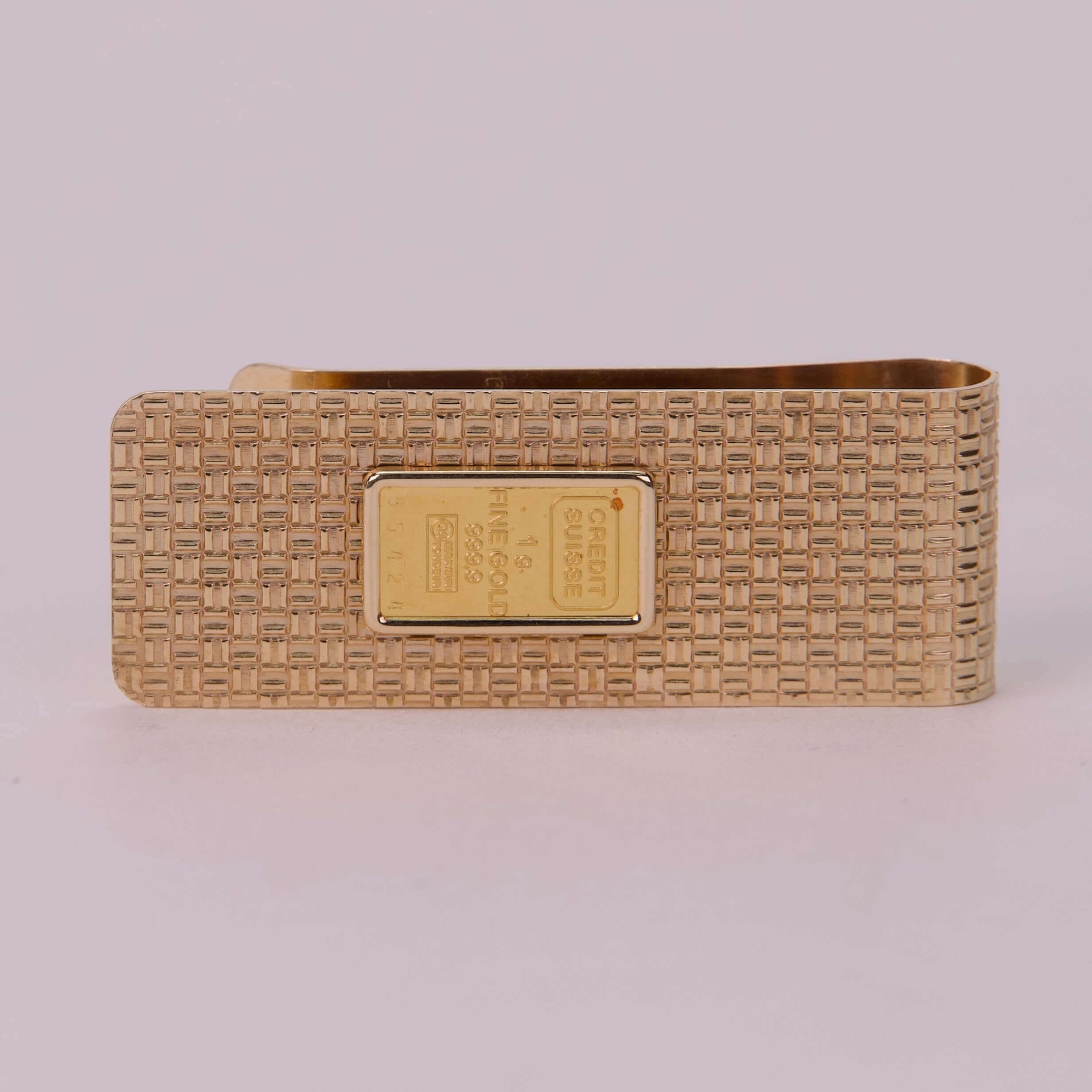 Gold money clip with textured design.