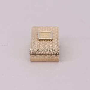 Gold textured rectangular lighter on display.