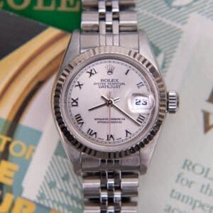 Silver Rolex Datejust watch with documents.