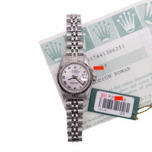 Luxury silver watch with documentation and tags.