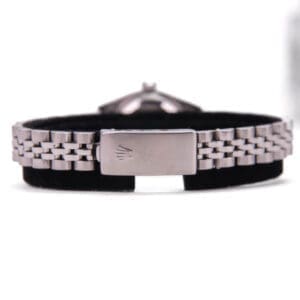 Silver watch bracelet with black background.
