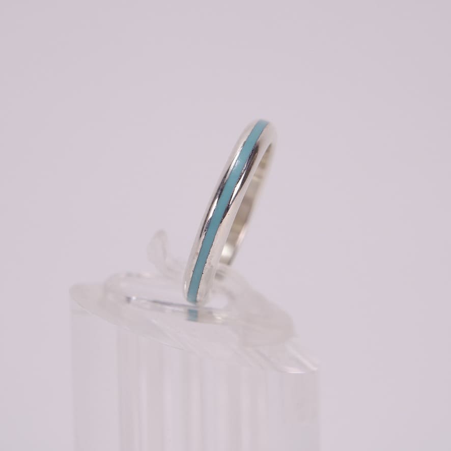 Silver ring with blue enamel stripe.