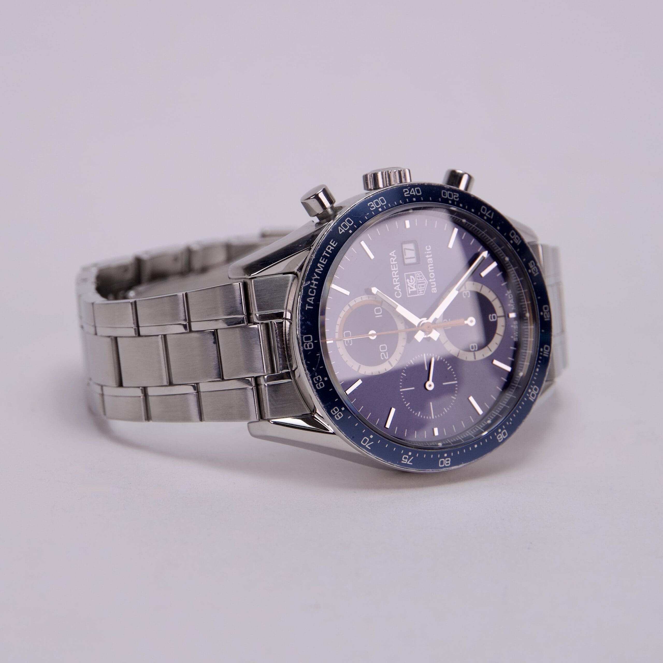 Silver chronograph watch with blue dial.