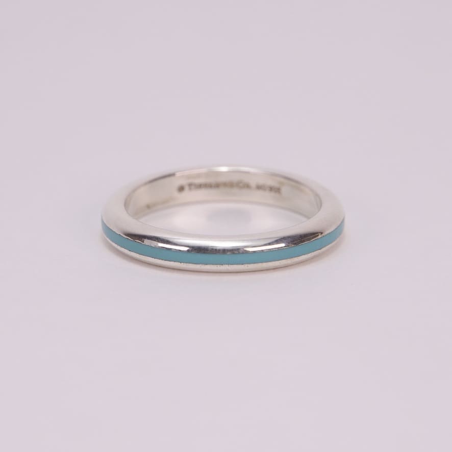 Silver ring with turquoise stripe detail.